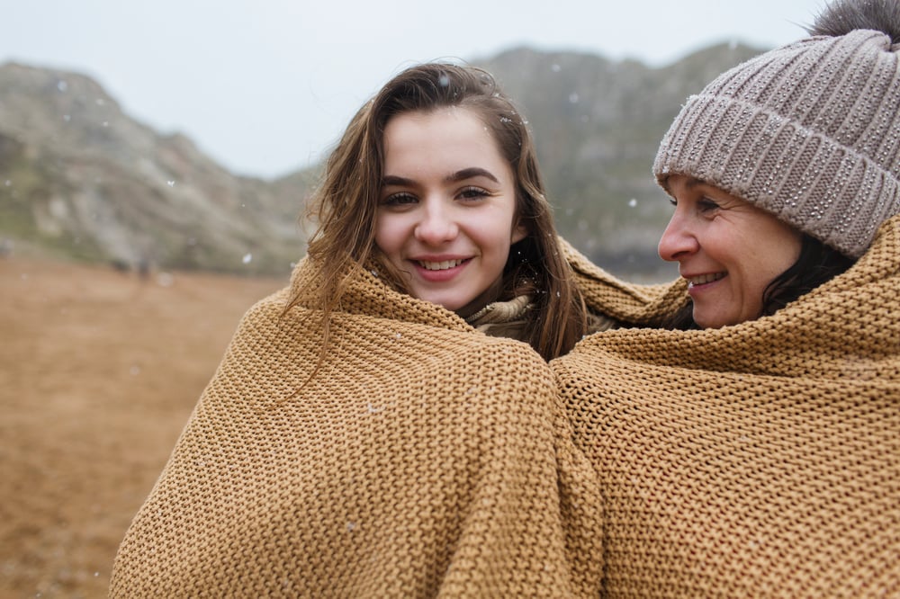 https://dissolve.com/stock-photo/Portrait-carefree-mother-daughter-wrapped-blanket-snowy-royalty-free-image/101-D1007-21-362
