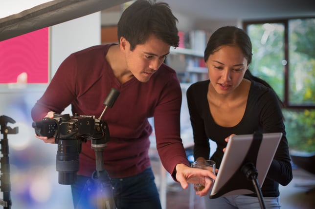 Couple looking at a screen while working