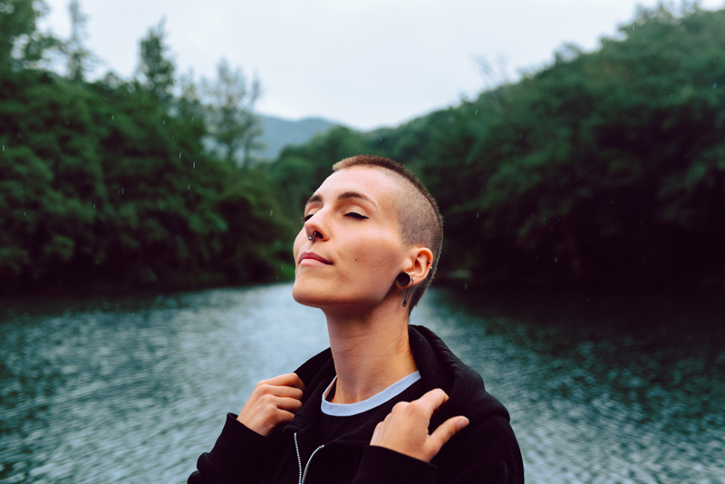 Individual with closed eyes soaking in the fresh air