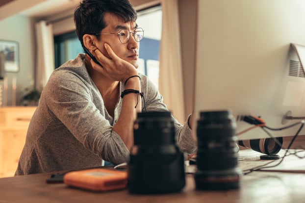 Male photographer contemplating his craft 